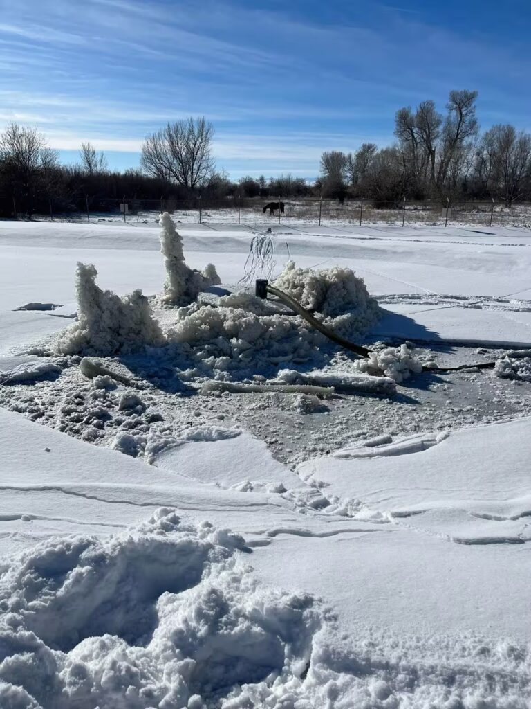 Titus FL Aerator operating beneath ice in extreme cold, supporting year-round sludge remediation in municipal lagoon systems
