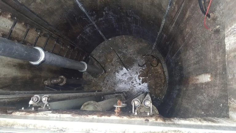 Interior view of a wastewater pump station showing grease matting, a common maintenance issue that leads to odors as dissolved sulfides convert to H2S gas, creating safety, odor, and corrosion concerns.