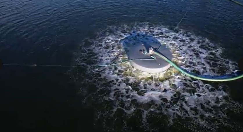 TITUS FL Floating Aerator operating in a wastewater lagoon, creating 360 degree aeration and mixing to restore dissolved oxygen and support biological sludge reduction.